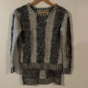 Size small, longer in the back, cute with tights